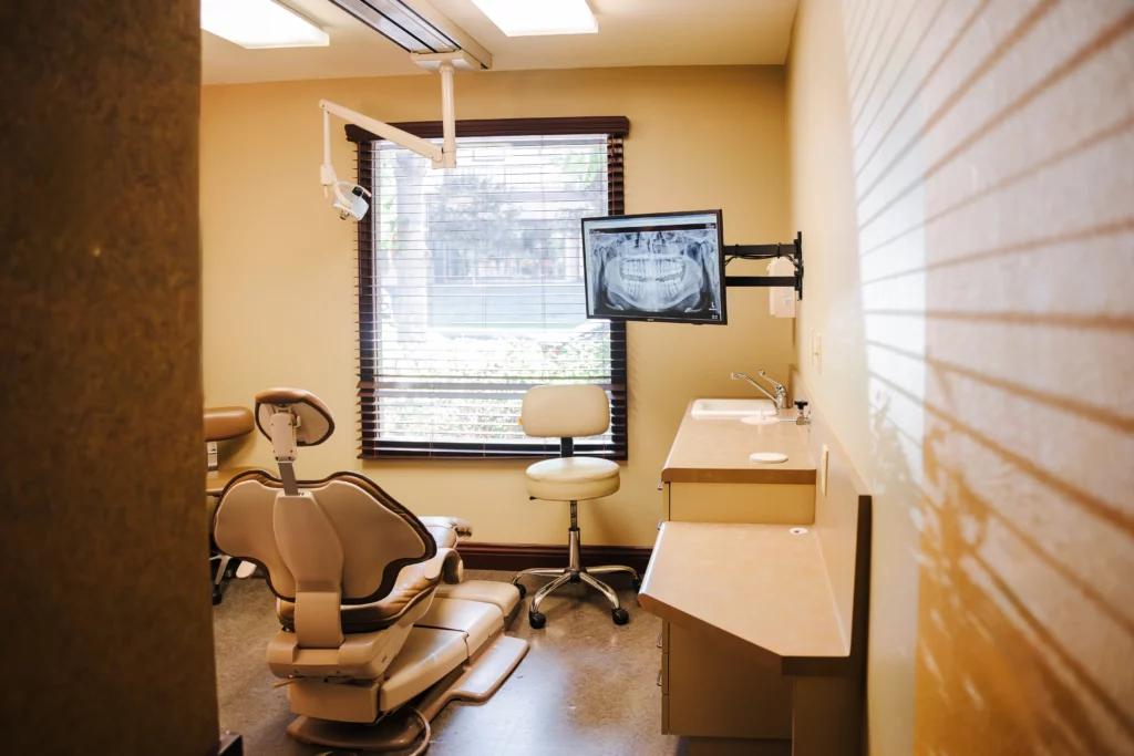 Treatment room at North County Dental Arts with a dental chair and X-ray monitor
