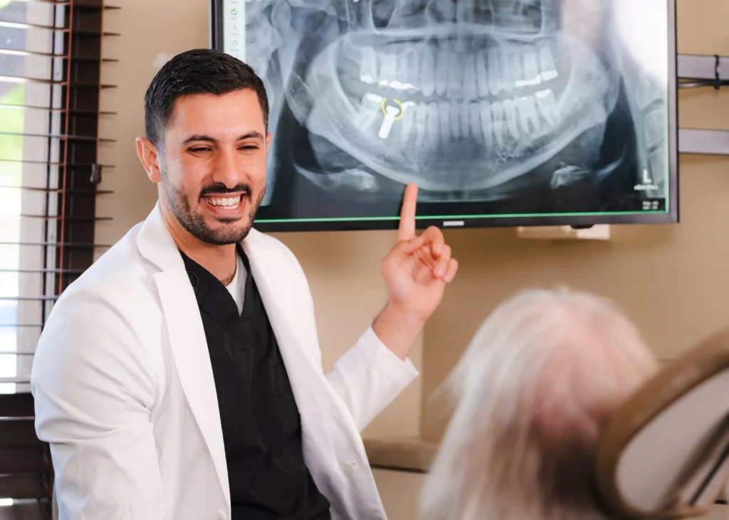 Dentist explaining dental X-ray results to patient in Escondido dental office
